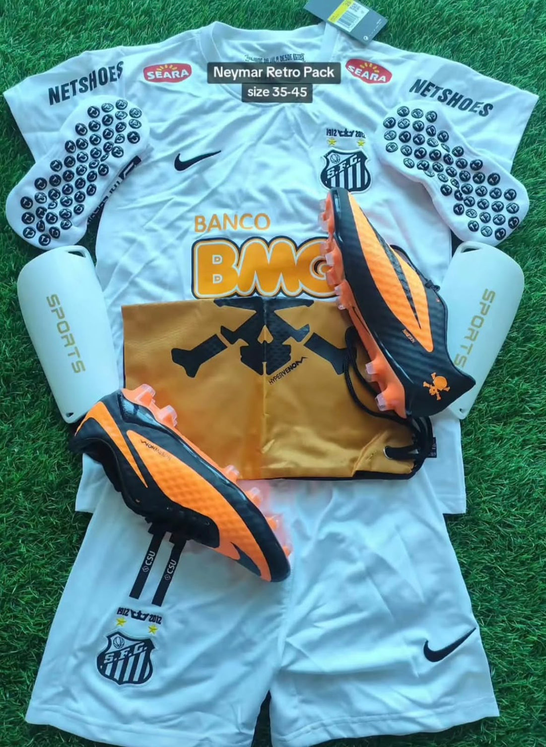 Neymar inspired Santos white football jersey orange and black boots and shin pads on grass