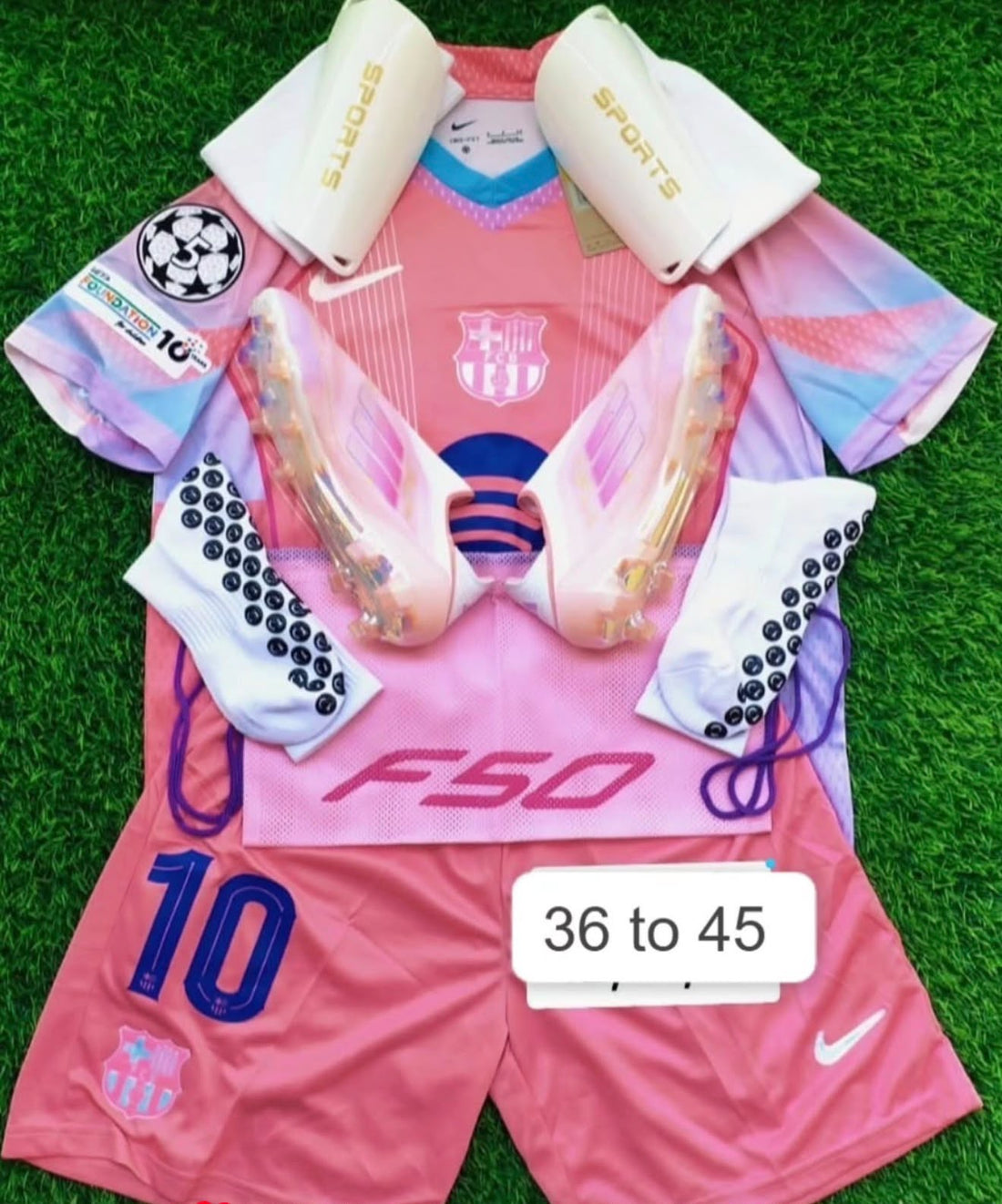 Pink F50 football boots pink jersey and matching training accessories on grass
